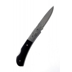 1T. Black knife with blade decorated with acid and textile cover